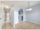 Open-concept dining area with tile flooring, flowing into a hallway and kitchen with blue cabinetry at 1424 Highland Ridge Cir, Brandon, FL 33510
