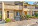 Beige two-story townhouse featuring a welcoming entrance, small garden, and convenient walkway at 1424 Highland Ridge Cir, Brandon, FL 33510