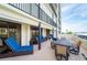 Expansive balcony with comfortable seating, dining set, and sliding glass doors at 1460 Gulf Blvd # 108, Clearwater, FL 33767