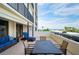 Inviting balcony with stylish seating offering partial ocean views and outdoor dining space at 1460 Gulf Blvd # 108, Clearwater, FL 33767