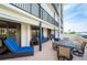 Expansive balcony with comfortable seating, outdoor dining area, and partial ocean view creates an inviting space at 1460 Gulf Blvd # 108, Clearwater, FL 33767