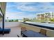 Relaxing balcony featuring a table and chairs with a view of the ocean and blue skies at 1460 Gulf Blvd # 108, Clearwater, FL 33767