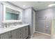 Bathroom with double sinks, marble countertop, and grey cabinets offers a stylish and functional space at 1460 Gulf Blvd # 108, Clearwater, FL 33767