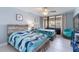 Charming bedroom with two beds, ocean-themed decor, and sliding glass doors to a balcony at 1460 Gulf Blvd # 108, Clearwater, FL 33767