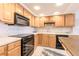 Well-maintained kitchen with black appliances, light cabinetry, and ample counter space at 1460 Gulf Blvd # 108, Clearwater, FL 33767
