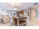 Comfortable living room with dining table and balcony access at 1460 Gulf Blvd # 108, Clearwater, FL 33767