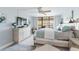 Relaxing main bedroom with balcony, tv, and dresser at 1460 Gulf Blvd # 108, Clearwater, FL 33767