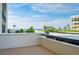 Breathtaking ocean view from balcony with palms and a neighboring building at 1460 Gulf Blvd # 108, Clearwater, FL 33767
