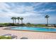 Sparkling community pool with lounge chairs, perfect for relaxation with ocean views and sunny skies at 1460 Gulf Blvd # 108, Clearwater, FL 33767