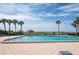 Inviting community pool with sun umbrellas, offering a resort-style experience with ocean views at 1460 Gulf Blvd # 108, Clearwater, FL 33767