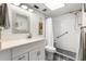 Bathroom featuring a glass enclosed shower, modern vanity, and ample lighting at 1701 Pinehurst Rd # 31D, Dunedin, FL 34698