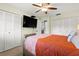 Bedroom offering dual closets, a queen bed, and mounted TV for entertainment at 1701 Pinehurst Rd # 31D, Dunedin, FL 34698