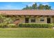 Charming condo with a red tile roof, complemented by lush landscaping and a well-manicured lawn at 1701 Pinehurst Rd # 31D, Dunedin, FL 34698