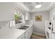 Bright kitchen with white cabinetry, stainless steel sink, and a window for natural light at 1701 Pinehurst Rd # 31D, Dunedin, FL 34698