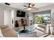 Inviting living room with wood-look floors, large TV, comfy sofa and outdoor views at 1701 Pinehurst Rd # 31D, Dunedin, FL 34698