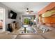 Open living room with sliding door to outdoor patio space, comfortable seating and home accents at 1701 Pinehurst Rd # 31D, Dunedin, FL 34698
