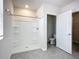 Bathroom featuring a white shower and view of the toilet and open closet at 18023 Canopy Pl, Bradenton, FL 34211