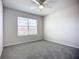 Bedroom with neutral carpet, ceiling fan, and bright window at 18023 Canopy Pl, Bradenton, FL 34211