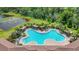 Aerial view of the community pool with trees and lounge chairs at 18023 Canopy Pl, Bradenton, FL 34211