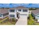 Two-story home with blue shutters, white exterior, and landscaping at 18023 Canopy Pl, Bradenton, FL 34211
