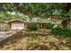Charming single-story home featuring a large, shady tree and a well-maintained front yard at 1868 Juarez S Way, St Petersburg, FL 33712