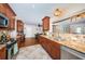 Bright kitchen features granite countertops, stainless steel appliances, and seamless flow into the dining area at 1868 Juarez S Way, St Petersburg, FL 33712