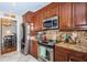 Kitchen features stainless steel appliances, granite countertops, and wood cabinetry at 1868 Juarez S Way, St Petersburg, FL 33712