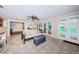 Living room leading to the outdoor pool area, featuring a patterned rug and lots of natural light at 1868 Juarez S Way, St Petersburg, FL 33712