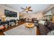 Open living area boasts hardwood floors, a ceiling fan, comfortable seating, and a seamless flow to the dining area at 1868 Juarez S Way, St Petersburg, FL 33712