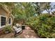 Cozy brick patio with outdoor seating, surrounded by lush greenery, creating a private retreat at 1868 Juarez S Way, St Petersburg, FL 33712