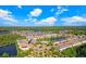 Community aerial view showcasing houses surrounding scenic ponds and lush green trees at 18737 Noble Caspian Dr, Lutz, FL 33558