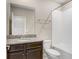 Well-lit bathroom featuring a granite countertop, large mirror, and shower with tile surround at 18737 Noble Caspian Dr, Lutz, FL 33558