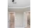 Bedroom with neutral walls, doorways leading to bathroom and walk-in closet at 18737 Noble Caspian Dr, Lutz, FL 33558