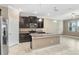 Bright kitchen with stainless steel appliances, granite countertops and an island with sink at 18737 Noble Caspian Dr, Lutz, FL 33558