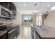 Kitchen featuring stainless steel appliances, granite countertops and tile floors at 18737 Noble Caspian Dr, Lutz, FL 33558