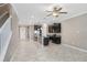 Open concept kitchen with black cabinets, stainless steel appliances and light tile floors at 18737 Noble Caspian Dr, Lutz, FL 33558