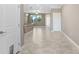 A open living room concept with white walls and light tile floors leading into the kitchen at 18737 Noble Caspian Dr, Lutz, FL 33558