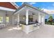 Covered outdoor kitchen area with a large bar, stainless steel grill, and ample seating at 18737 Noble Caspian Dr, Lutz, FL 33558