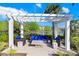 Covered patio area featuring stylish seating, perfect for relaxing and entertaining by the lake at 18737 Noble Caspian Dr, Lutz, FL 33558