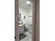 Well-lit bathroom with tile floor, sink, and toilet offers a clean and functional space at 1903 Canterbury Ln # B2, Sun City Center, FL 33573