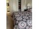 Comfortable bedroom features a patterned comforter and ample closet space at 1903 Canterbury Ln # B2, Sun City Center, FL 33573