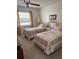Bright bedroom with two twin beds, large windows, and comfortable decor at 1903 Canterbury Ln # B2, Sun City Center, FL 33573