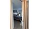 Hallway view of a bedroom with a patterned comforter and yellow dresser at 1903 Canterbury Ln # B2, Sun City Center, FL 33573