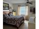 Bedroom with ceiling fan, large windows, and coordinated furniture and decor at 1903 Canterbury Ln # B2, Sun City Center, FL 33573