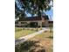 Exterior view of the community clubhouse featuring a covered entrance at 1903 Canterbury Ln # B2, Sun City Center, FL 33573