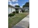 Well-maintained home featuring lush landscaping and a paved walkway at 1903 Canterbury Ln # B2, Sun City Center, FL 33573