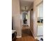 Hallway view with glimpse of kitchen appliances and parquet flooring at 1903 Canterbury Ln # B2, Sun City Center, FL 33573