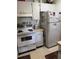 Kitchen with white appliances, including an oven and refrigerator, plus white cabinets at 1903 Canterbury Ln # B2, Sun City Center, FL 33573