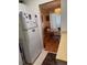 View of kitchen area with refrigerator, cabinets, and glimpse into a dining area at 1903 Canterbury Ln # B2, Sun City Center, FL 33573