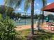 Outdoor pickleball court with players and onlookers with shaded seating at 1903 Canterbury Ln # B2, Sun City Center, FL 33573